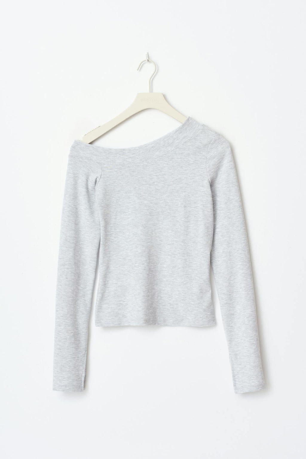 Sloped shoulder top
