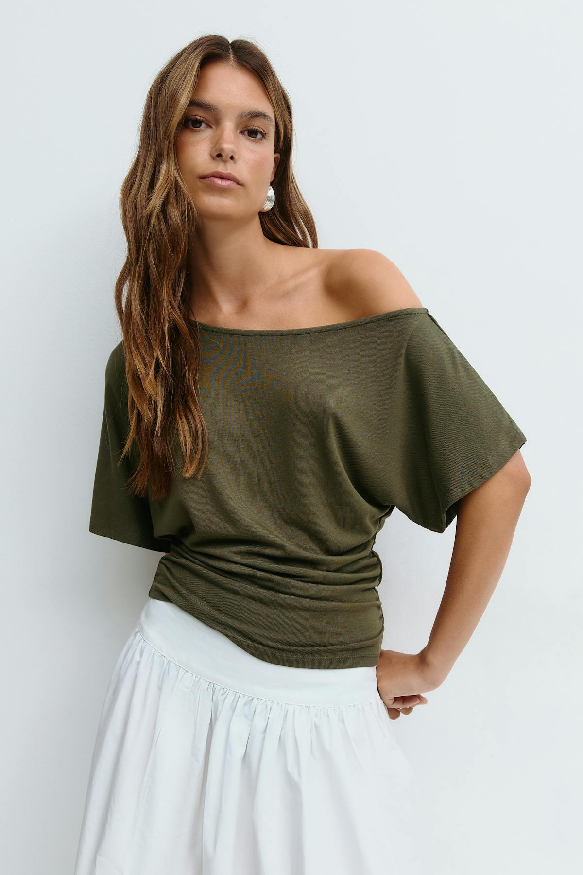 Sloped shoulder top