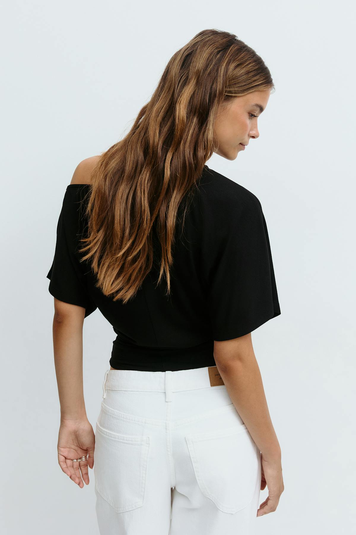 Sloped shoulder top