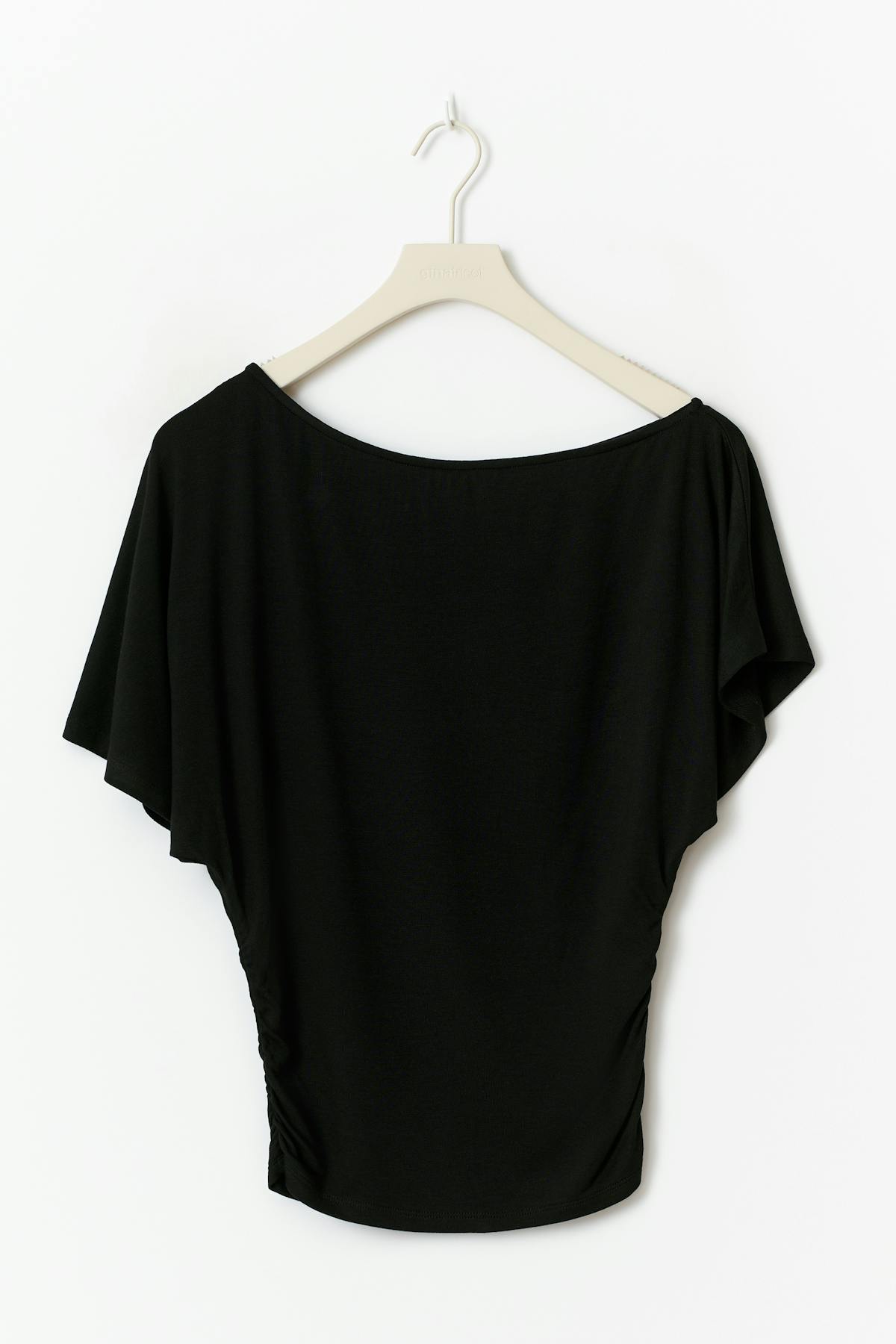 Sloped shoulder top