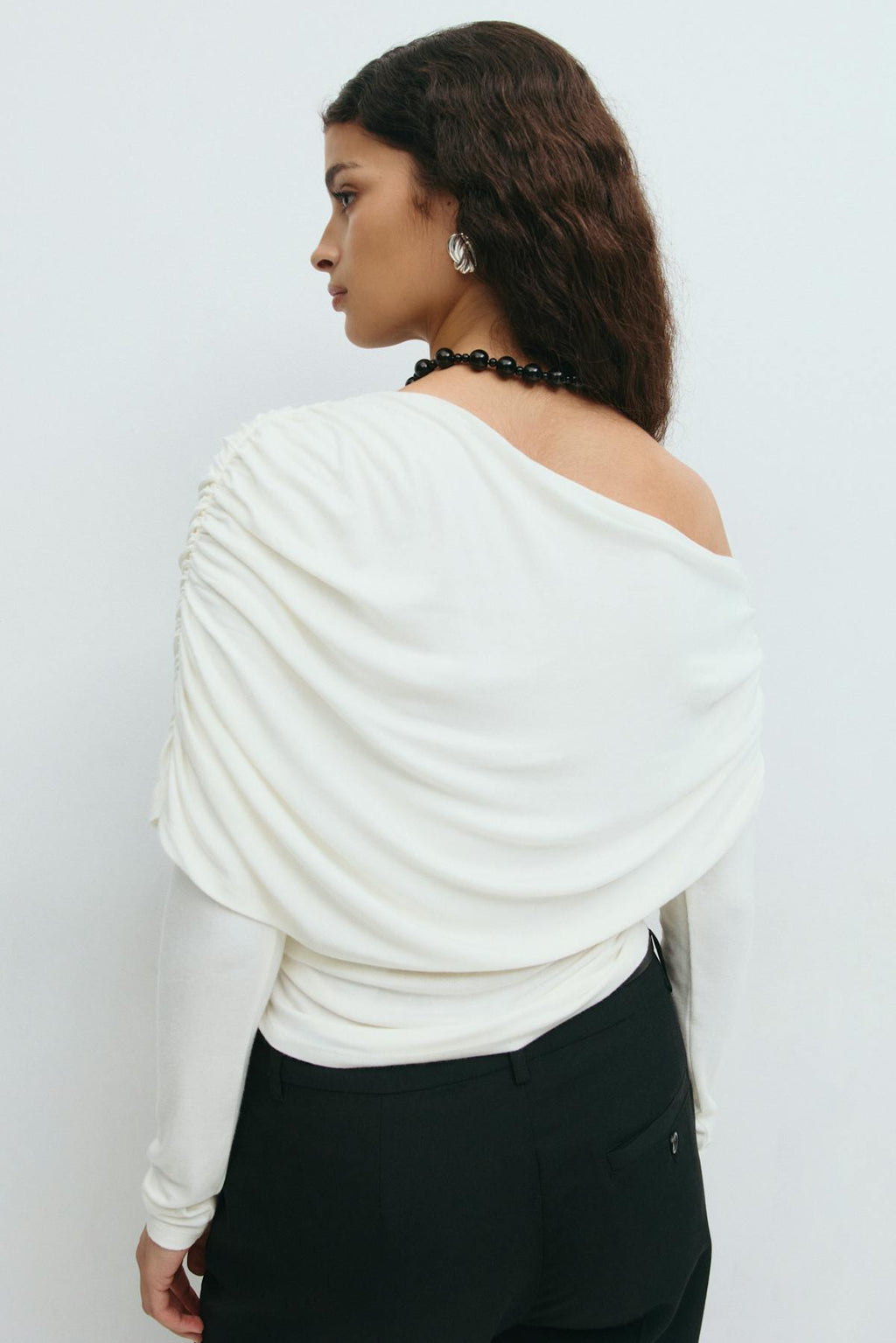 Sloped shoulder cape top