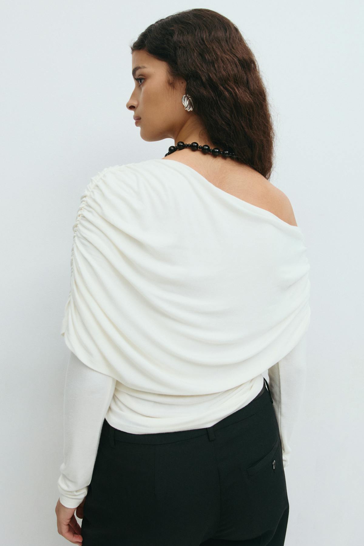 Sloped shoulder cape top