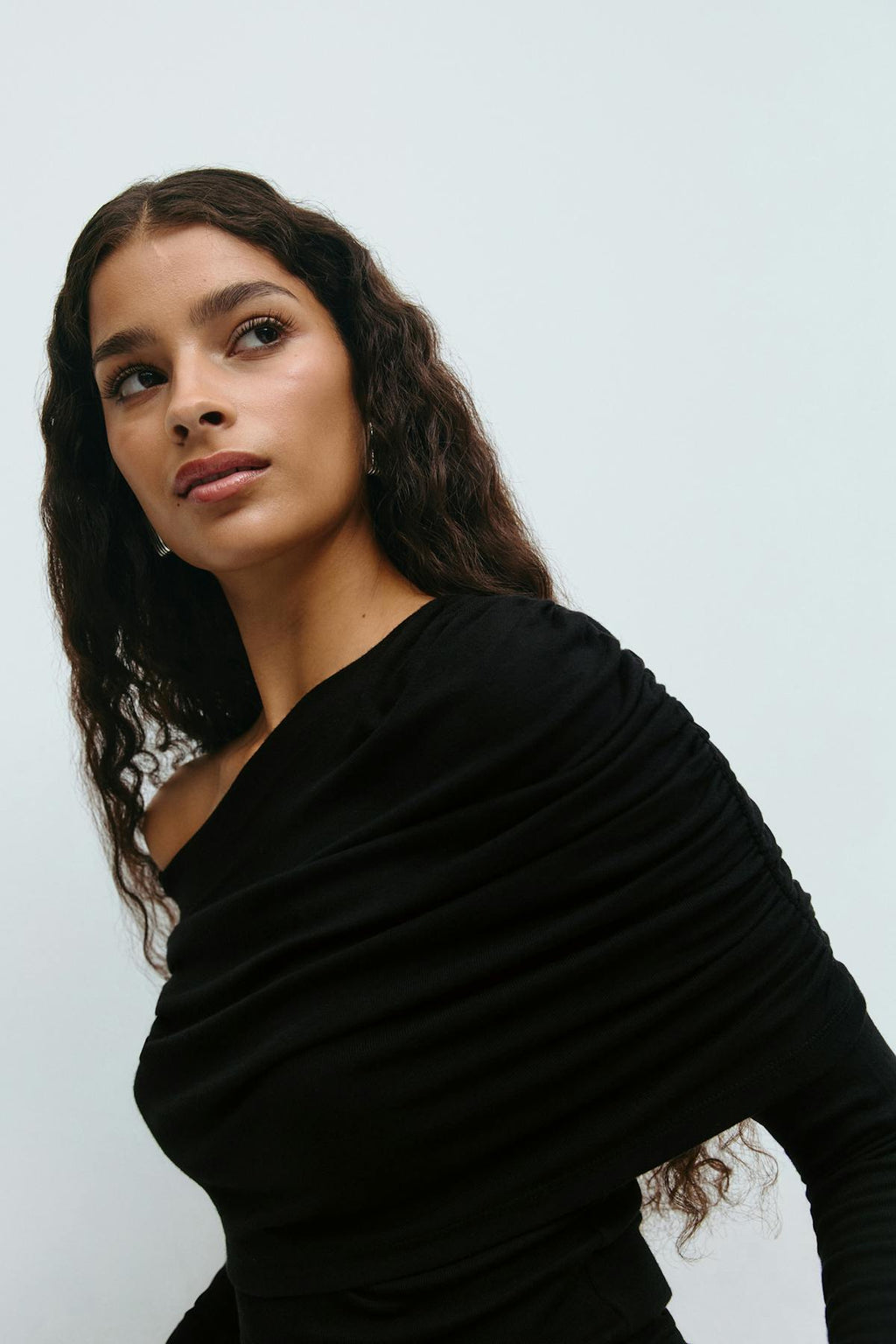 Sloped shoulder cape top