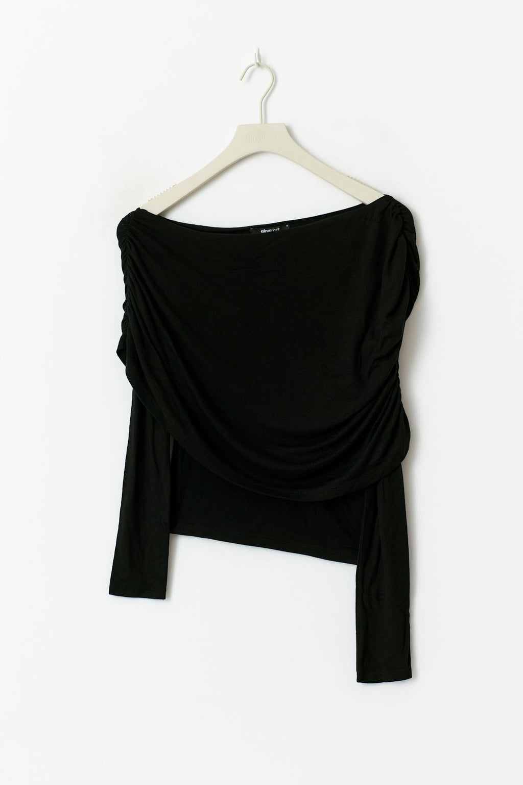 Sloped shoulder cape top